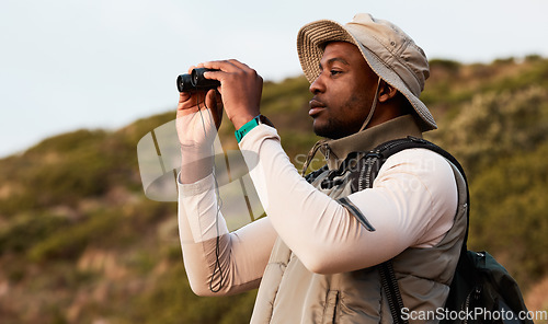 Image of Hiking, binocular or black man on mountain in nature on trekking journey or adventure for freedom. View, holiday vacation or African hiker walking to search in park for exercise, fitness or wellness