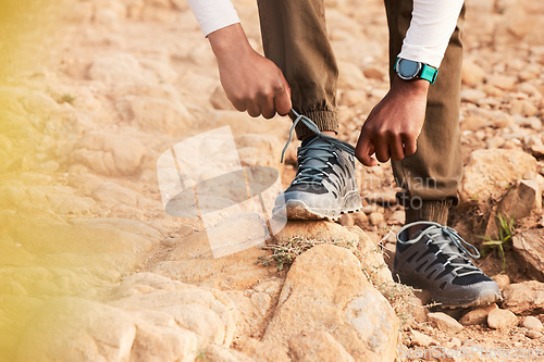 Image of Tie, mountain or hands of hiker with shoes for fitness training, exercise or outdoor workout. Lace, walking closeup or legs of person with footwear ready to start hiking on rock or ground in nature