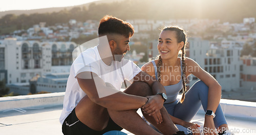 Image of Couple, fitness and city to rest and talk for exercise, workout or training together on rooftop. Happy man and woman on sports break with a laugh, communication or conversation about wellness