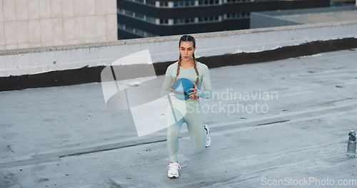 Image of Fitness, medicine ball and woman athlete in the city for a health, wellness and cardio workout or exercise. Equipment, sports and young female person training on building rooftop in urban town.