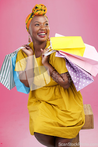 Image of Shopping, thinking and black woman with bags, luxury items and fashion on a pink studio background. African person, customer or model with expensive clothes, retail or boutique products with decision