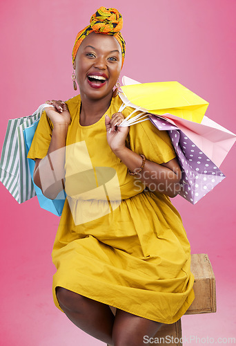 Image of Shopping bag, studio portrait and black woman excited for discount promotion, fashion spree choice or commerce deal. Market product, package or African customer with retail present on pink background