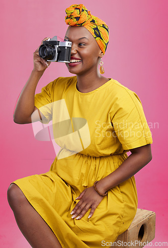 Image of Camera, studio and happy black woman shooting photo, picture or photography of creative fashion design. Creativity photoshoot, talent artist and African production photographer on pink background