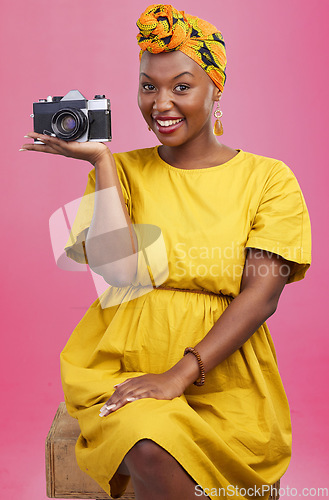 Image of Camera, photographer portrait and happy black woman for lens photo, profile picture or creative photography, fashion or beauty. Studio photoshoot, happiness or African person smile on pink background