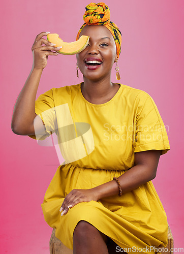 Image of Melon, portrait and black woman in studio with diet, advice or lose weight with cantaloupe tips on pink background. Fruit, detox and African lady nutritionist with organic, cleanse or raw food advice