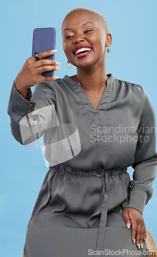 Image of Happy, selfie and black woman excited for mobile app video call isolated in studio blue background with prize. Connection, African and happy person or content creator live streaming on social media