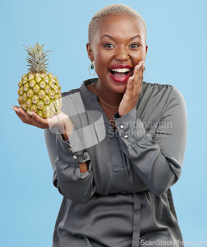 Image of Portrait, wow and black woman pineapple in studio for detox, lose weight or diet nutrition on blue background. Fruit, face and African lady nutritionist show vegan, lifestyle or organic diet choice