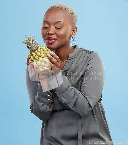 Image of Pineapple, diet and black woman in studio with advice, lose weight or digestion and gut health tips on blue background. Fruit, detox or African nutritionist with organic, raw and superfoods guide