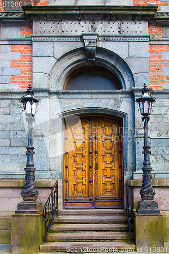 Image of Old door with lamp poles