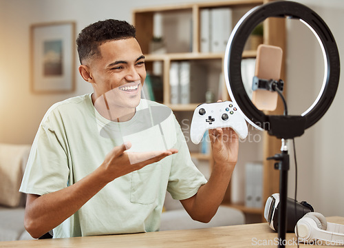 Image of Man, live streaming for gaming and social media influencer, .smartphone filming tech review, online gamer with controller. Video game promo, streamer with ring light for content creation and feedback