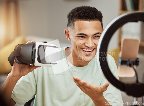 Image of Ring light, influencer and man with virtual reality headset review in his home live streaming to blog or podcast. Social media, feedback and male gamer with vr goggles for esports, gaming or update