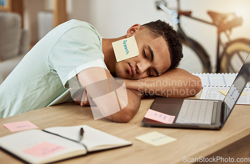 Image of Sleeping, laptop and tired business man in office with paper, research or note on face at desk for nap. Work, burnout and guy designer with insomnia, low energy or boring online task, lazy or fatigue