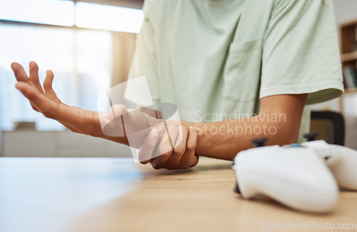 Image of Gaming, hand pain and man in living room with carpal tunnel, inflammation or esports injury zoom. Wrist, injury and male gamer with arthritis, fibromyalgia or osteoporosis, accident or anatomy crisis