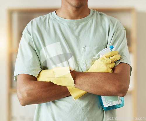 Image of Man, hands and spray bottle in housekeeping, cleaning or bacteria and germ removal at home. Closeup of male person, maid or cleaner with arms crossed of professional in domestic service at house