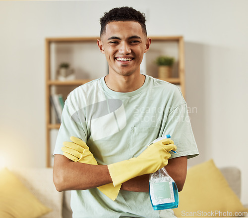 Image of Cleaner, man in portrait and chemical with arms crossed, happy and hygiene with housekeeping, detergent and gloves. Janitor, cleaning solution in bottle with smile and professional housekeeper