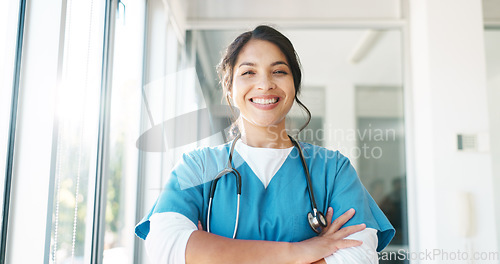 Image of Doctor in portrait, woman with arms crossed and healthcare, smile with confidence at hospital with pride and help. Medical professional, trust and consultation at clinic with scrubs and medicine