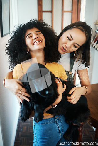 Image of Dog, hug and happy lesbian couple in home, bonding or having fun together. Pet, gay women smile and embrace animal for care in healthy relationship, love connection and funny laugh of lgbtq people