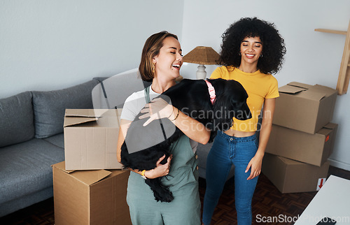 Image of Moving, lesbian and couple with dog in new home, boxes and smile in real estate together. Property, mortgage and lgbt women with puppy in living room happy and excited for pet, love and house