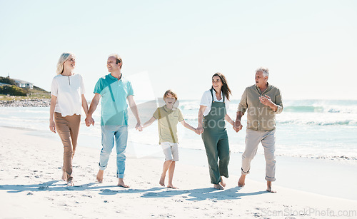 Image of Walking, beach and family holding hands together on vacation, holiday or tropical weekend trip. Happy, travel and child with parents and grandparents bonding by ocean or sea on adventure in Australia