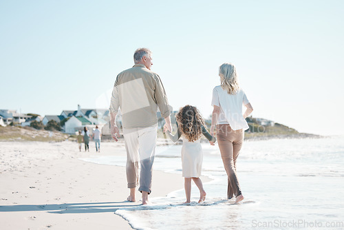 Image of Relax, holding hands and grandparents with child at beach for travel, love and support. Summer vacation, care and retirement with family walking on seaside holiday for adventure, bonding and peace