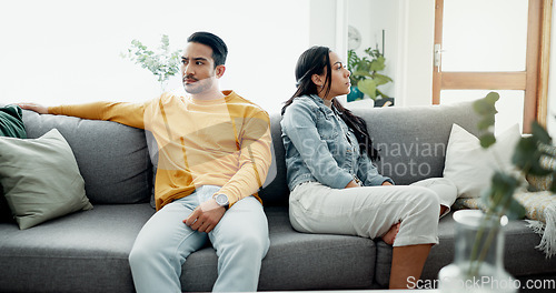 Image of Unhappy, fight and couple angry on a couch together duo to infertility, argument and toxic relationship in a home. Conflict, divorce and man has problem with woman in a living room sofa for cheating