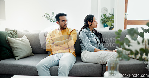 Image of Conflict, fight and couple angry on a couch together duo to infertility, argument and toxic relationship in a home. Unhappy, divorce and man has problem with woman in a living room sofa for cheating
