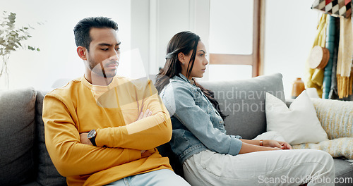 Image of Conflict, fight and couple angry on a couch together duo to infertility, argument and toxic relationship in a home. Unhappy, divorce and man has problem with woman in a living room sofa for cheating