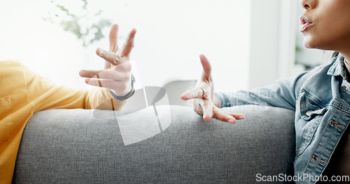 Image of Argument, hands and closeup of couple on a sofa in the living room for cheating, fight or toxic relationship. Conversation, discussion and zoom of man and woman talking for communication at home.