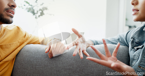 Image of Argument, hands and closeup of couple on a sofa in the living room for cheating, fight or toxic relationship. Conversation, discussion and zoom of man and woman talking for communication at home.