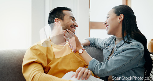 Image of Conversation, funny and couple on sofa in home living room, bonding and having fun. Smile, communication of man and woman in lounge for healthy connection of love, happy or laughing together in house