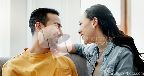 Image of Conversation, funny and couple on sofa in home living room, bonding and having fun. Smile, communication of man and woman in lounge for healthy connection of love, happy or laughing together in house