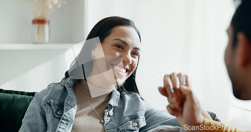 Image of Couple, kiss on hand and talking on home sofa with smile, security and love in healthy relationship. Young man and woman together in living room for affection, funny laugh and communication with care