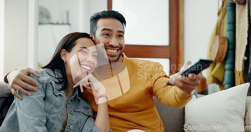 Image of Happy couple, relax and watch movies on tv, news and cable show for media broadcast on sofa at home. Man, woman and people change television remote for streaming multimedia, subscription and choice