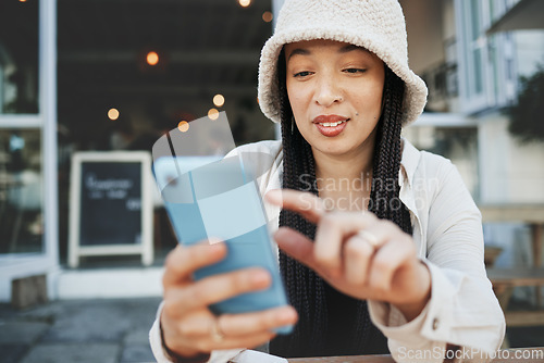 Image of Travel, student and woman with phone at a cafe for social media, texting or chatting in a city. Smartphone, app and lady influencer at coffee shop for content creation, podcast or traveling blog post
