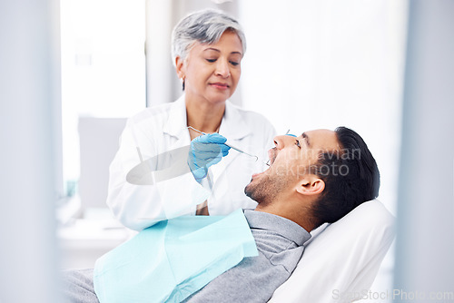 Image of Woman, dentist and check teeth of man with tools for dental cosmetics, healthcare assessment and medical consulting. Patient, tooth and oral cleaning with mirror, excavator and orthodontic surgery