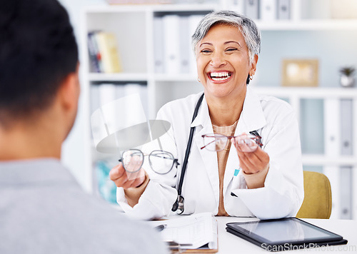 Image of Optometrist, office and talking to patient with glasses in hands for vision on tech, screen or lens for protection of eyes. Optometry, consultation and doctor with advice, tablet or choice in eyewear