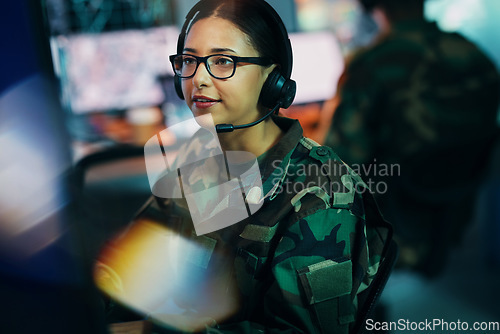 Image of Army command center, computer and woman in headset, global surveillance and tech for communication. Security, intelligence and soldier at desk in military office at government cyber data control room