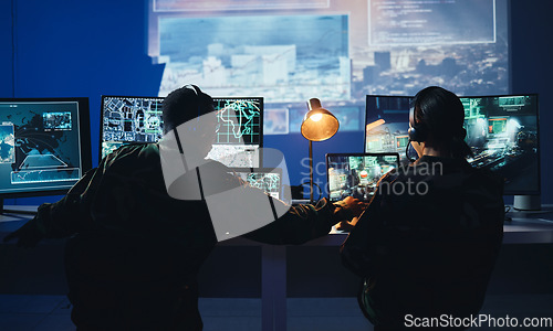 Image of Army control room, computer and team in surveillance, help and collaboration in tech communication from back. Security, satellite map and man with woman at monitor in military office command center.