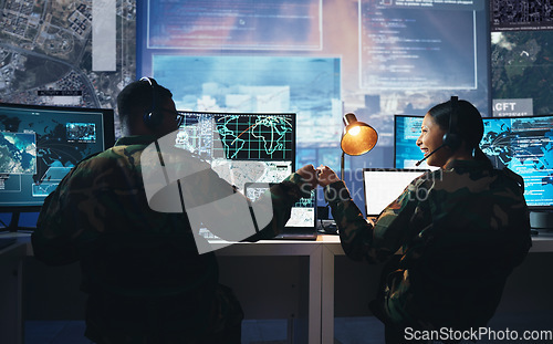 Image of Control room, military and fist bump by soldier team on surveillance together at night for communication. Technology, global and teamwork by security with success on satellite map in army office