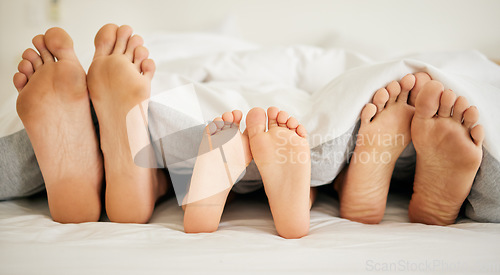 Image of Feet, family and sleeping on bed in bedroom of home together for rest, relax and comfort in the morning. Apartment, mattress and people nap for stress relief, vacation or weekend in san francisco