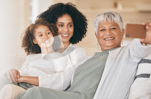 Image of Family, selfie and living room couch with a smile, grandmother and child together with mom. Bonding, sofa and happy mother with a young girl and senior woman with photo for social media post at home