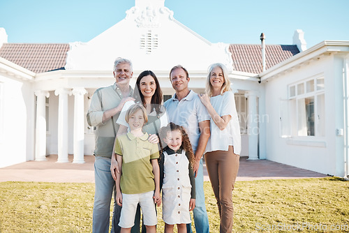 Image of Happy big family, portrait and real estate on grass in new home, property or investment on outdoor lawn. Parents, grandparents and kids smile for moving in, house or bonding in happiness together