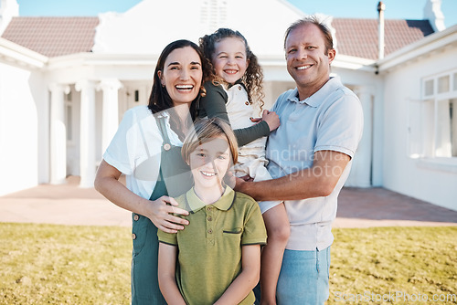 Image of Happy family, portrait and real estate in new home, property or investment on outdoor grass or lawn. Mother, father and kids smile for moving in, house or bonding in happiness or embrace together