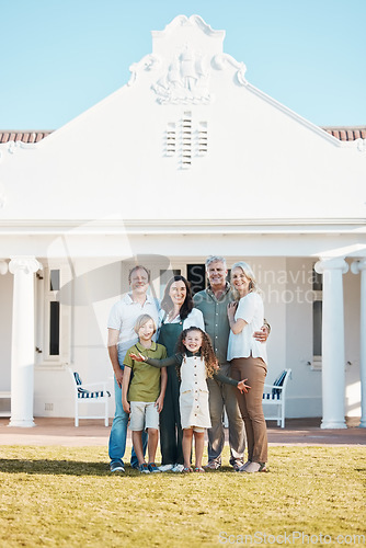 Image of Happy big family, portrait and hug in real estate, new home or property investment on outdoor grass or lawn. Parents, grandparents and kids smile for moving in, house or bonding in happiness together