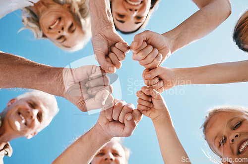 Image of Happy big family, hands and fist bump in teamwork, motivation or unity for support or trust on sky background. Low angle of people smile touching in team collaboration, community or outdoor goals