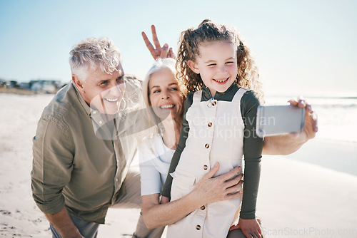Image of Family, selfie and beach holiday with peace sign, grandparents and young girl with a smile. Happy, child and love at the sea and ocean with a profile picture for social media on summer vacation