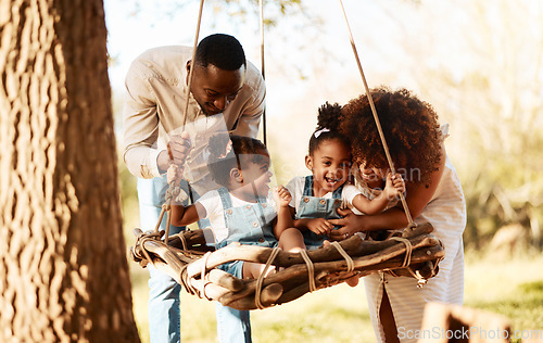 Image of Parents with kids in park, tree swing and freedom for love, bonding or peace in nature together. Mother, father and children adventure in garden, black family on summer weekend in woods or forrest.