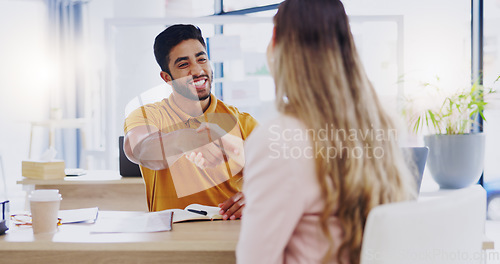 Image of Smile, business people and handshake for partnership, deal or introduction in workplace. Happy, man and woman shaking hands for agreement, b2b or onboarding, congratulations or welcome to company.