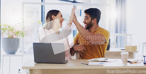 Image of Creative business people, laptop and high five for winning, success or planning together in teamwork at office. Happy man and woman touching hands on touchscreen for team collaboration or achievement