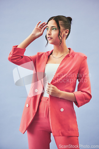 Image of Fashion, suit and woman in studio thinking, confidence and body in beauty aesthetic. Makeup, style and influencer girl in designer clothes, trendy promo or confident model standing on blue background